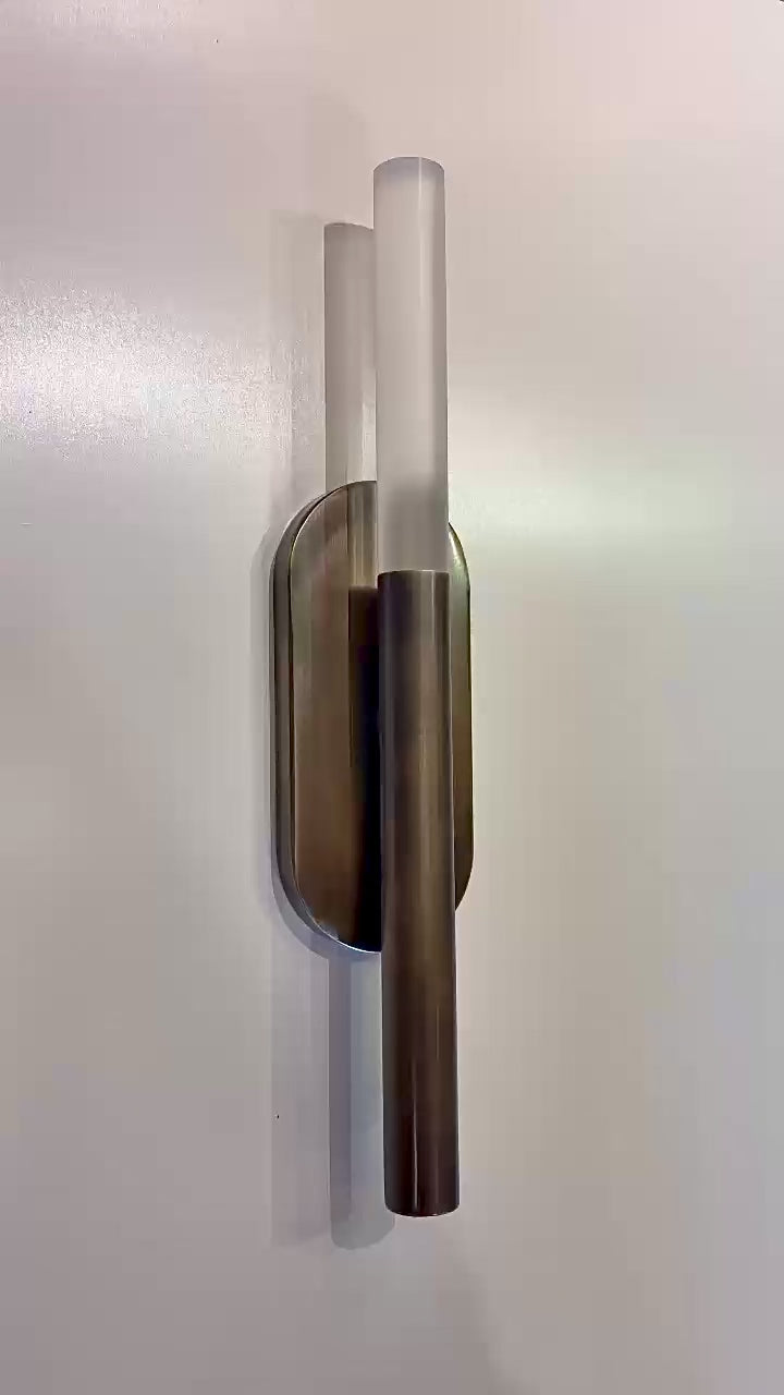 Video of the MUSALA modern wall sconce showing its finish and light